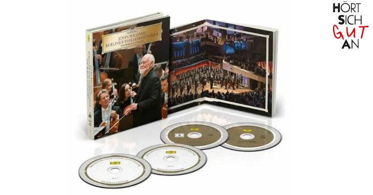 "John Williams - The Berlin Concert" Pure Audio BluRay, präsentiert im Adventskalender-Angebot von HSGA Bielefeld, mit Goldfolien-Optik auf dem Cover.